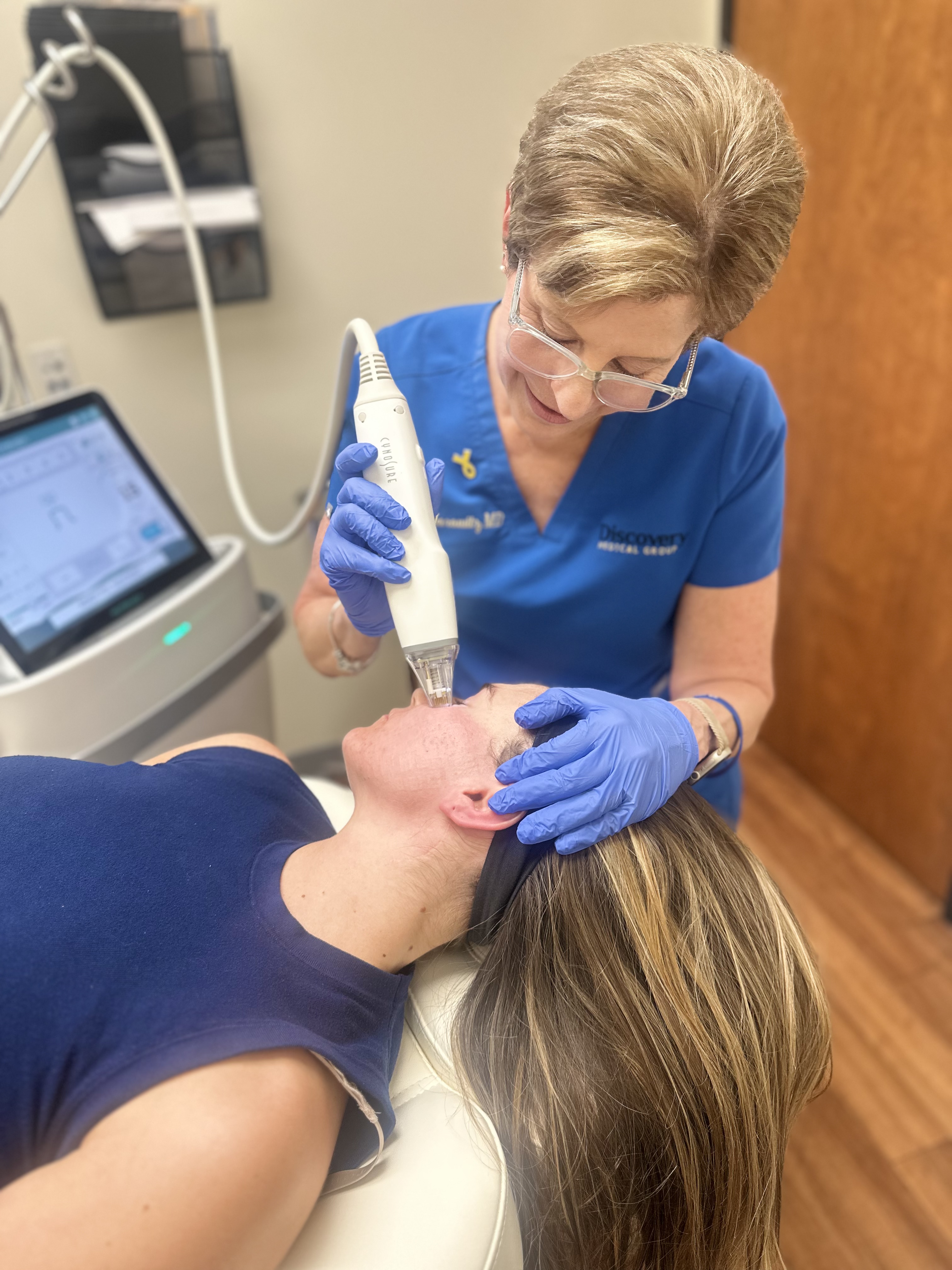 woman performing Potenza RF Microneedling on patient